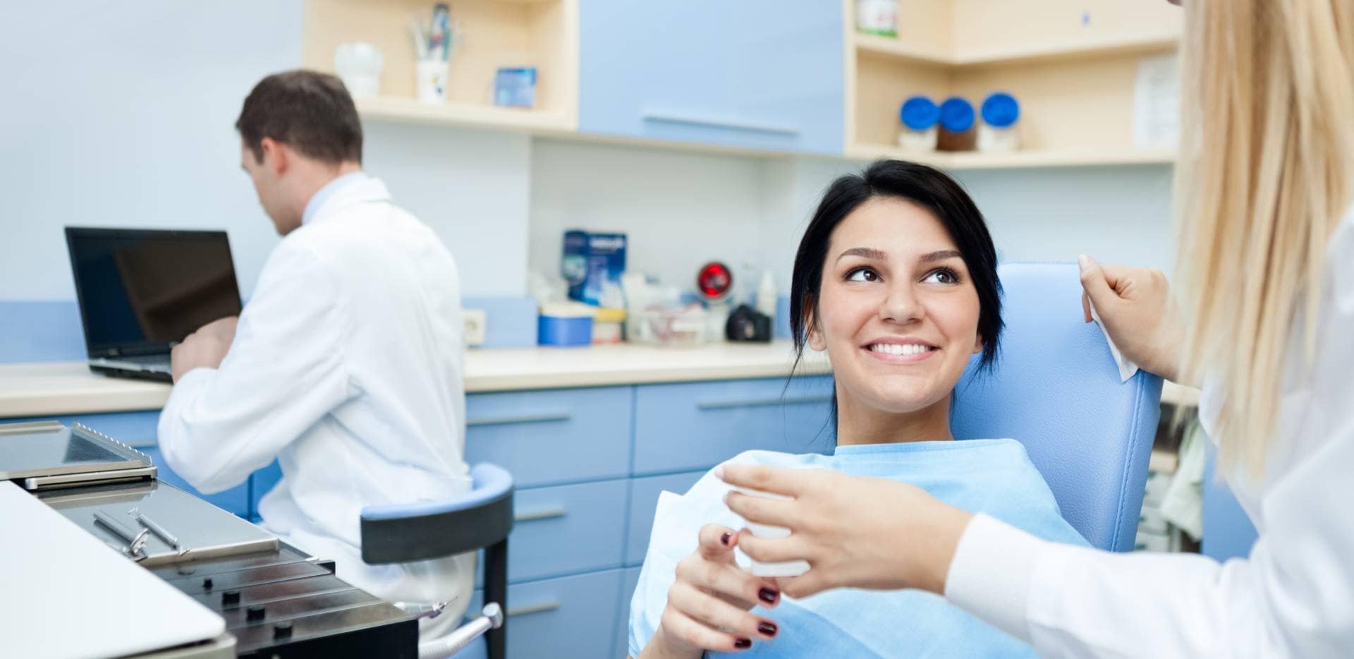 Pacientka s úsmevom komunikuje s dentálnou hygieničkou.